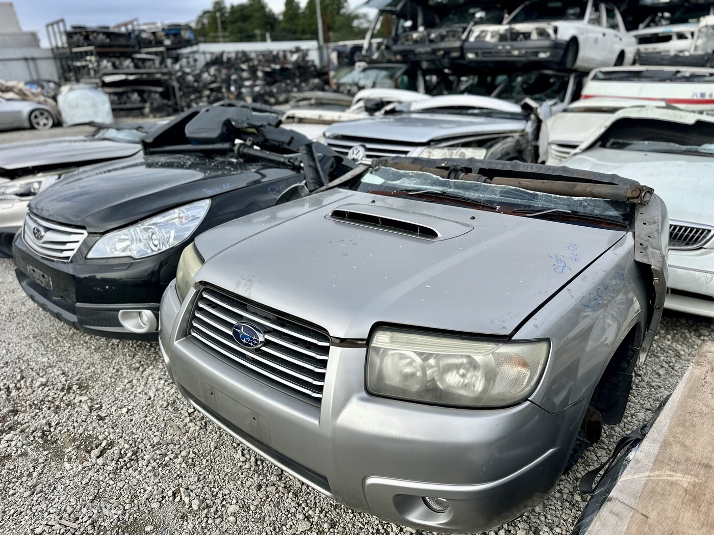 Dismantled Subaru and Toyota front sections in the parts yard