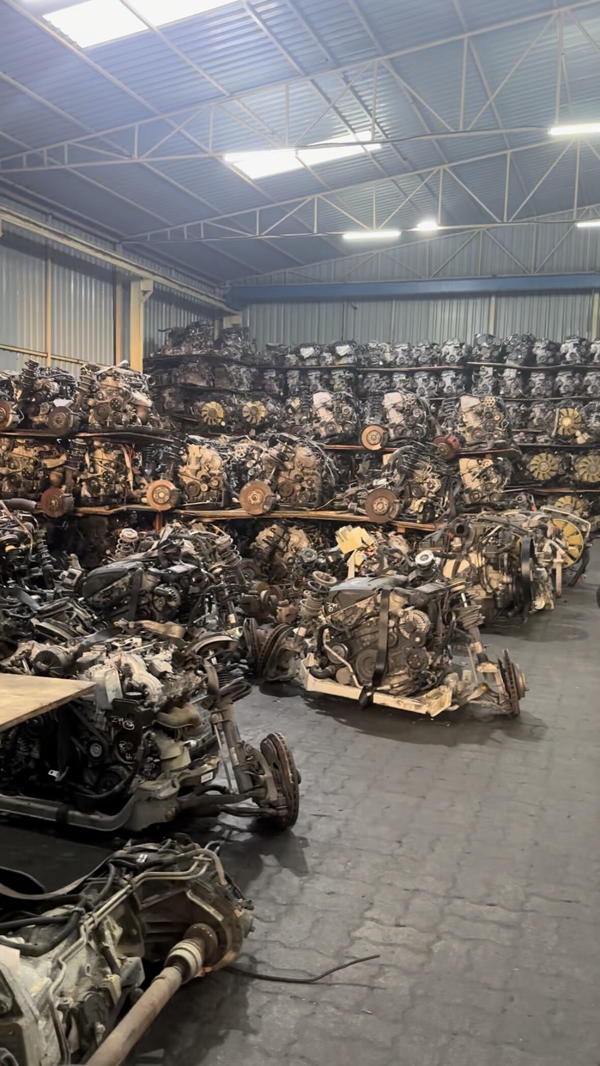 Used engines stored on racks in the outdoor yard