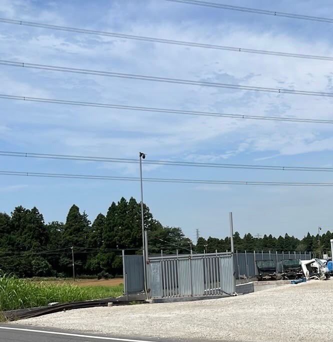 Gotencho Vehicle Storage Yard — roadside entrance with metal gate and perimeter fencing