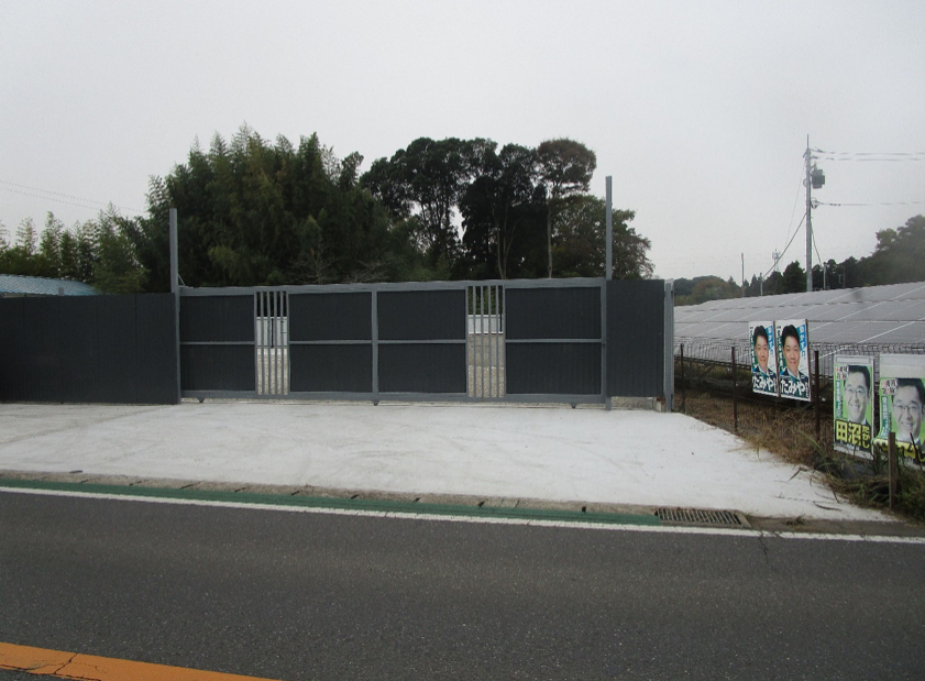 Sakura Industrial Yard — entrance gate and gravel access area
