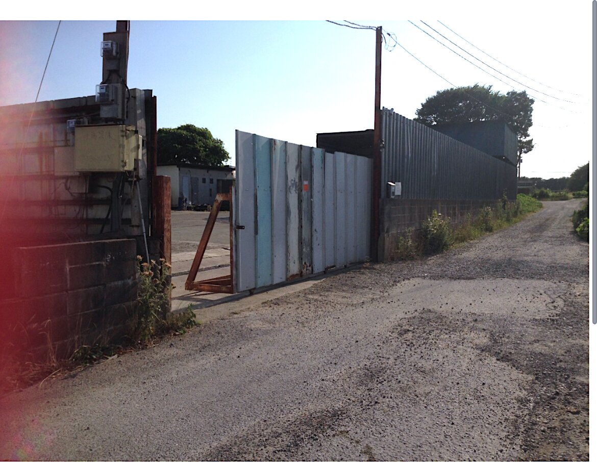 Yotsukaido Industrial Yard — access lane beside the entrance gate