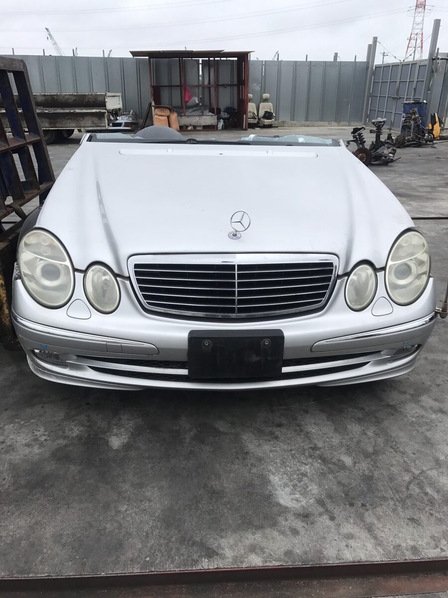 White Mercedes-Benz car parked in a vehicle yard