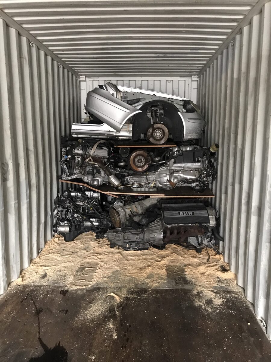 Vehicle front section stacked over engines with packing material on the floor