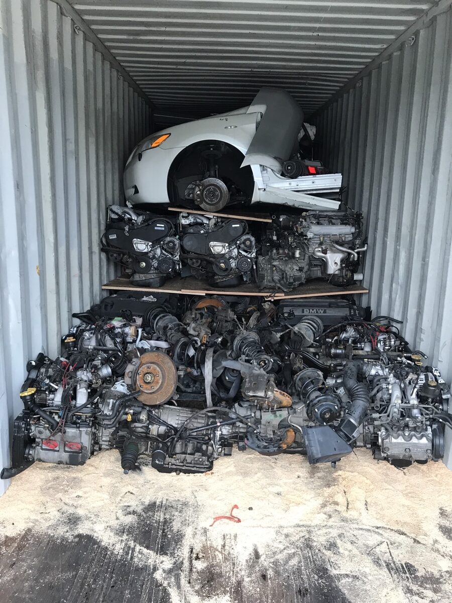 White vehicle section above tightly packed engines at a container entrance