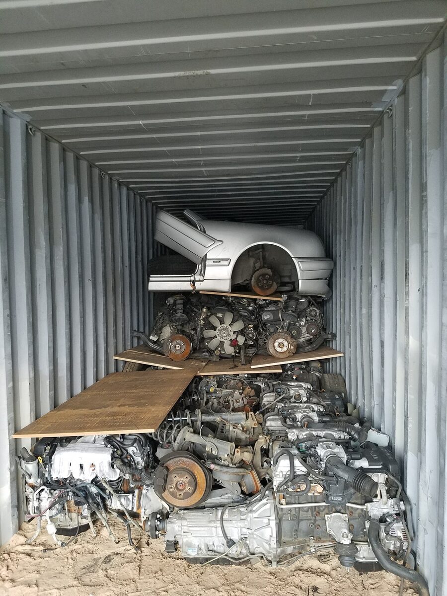 Engines and transmissions packed beneath wooden loading boards