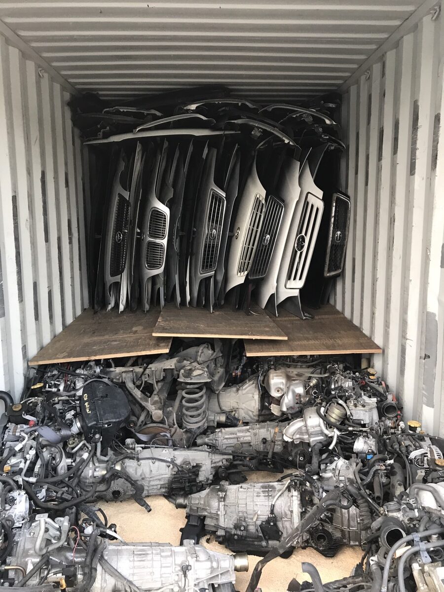 Upright body panels behind stacked engines inside a container