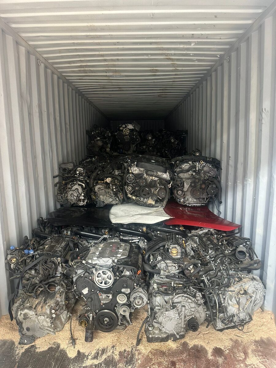 Engine assemblies stacked in a gray shipping container