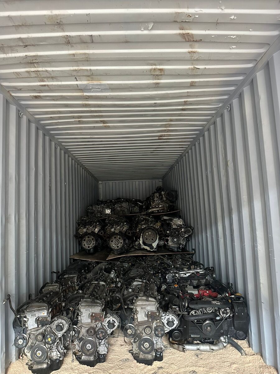 Engines stacked at the back of a container above loose packing material