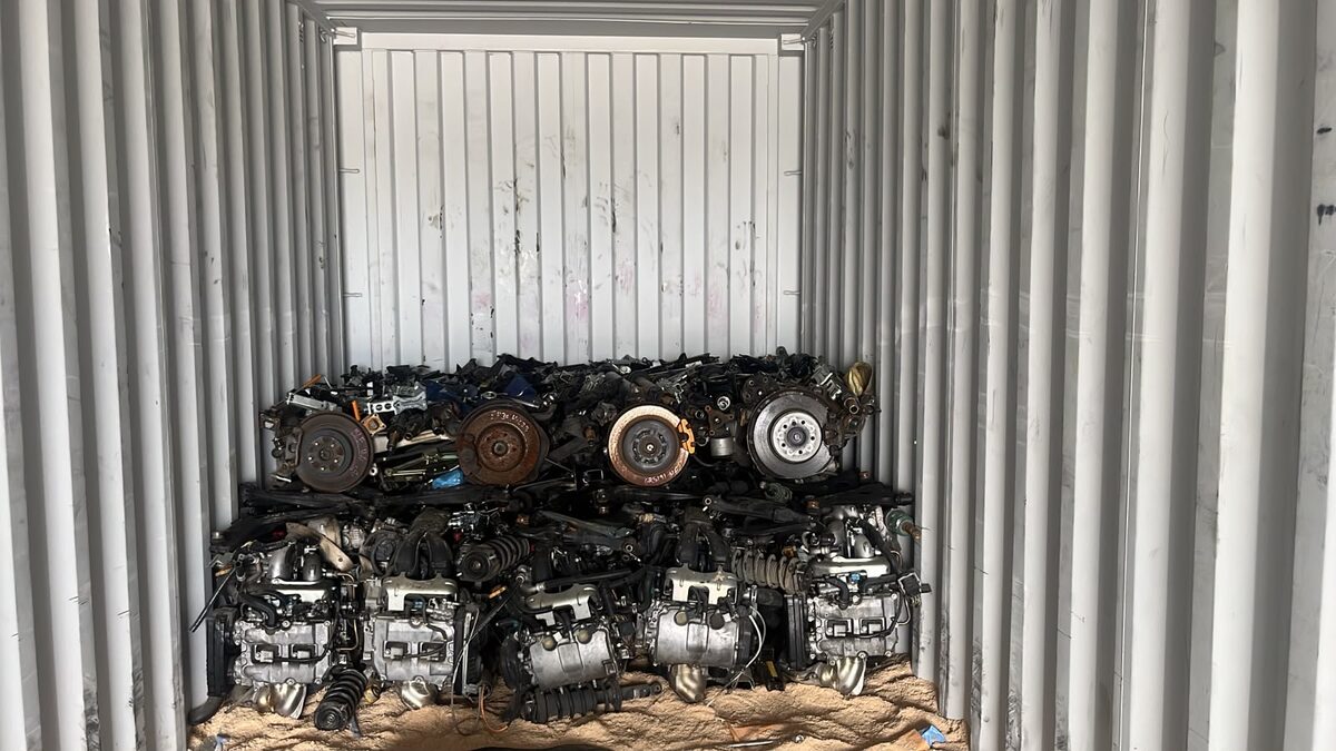 Two tiers of engines against a corrugated container wall