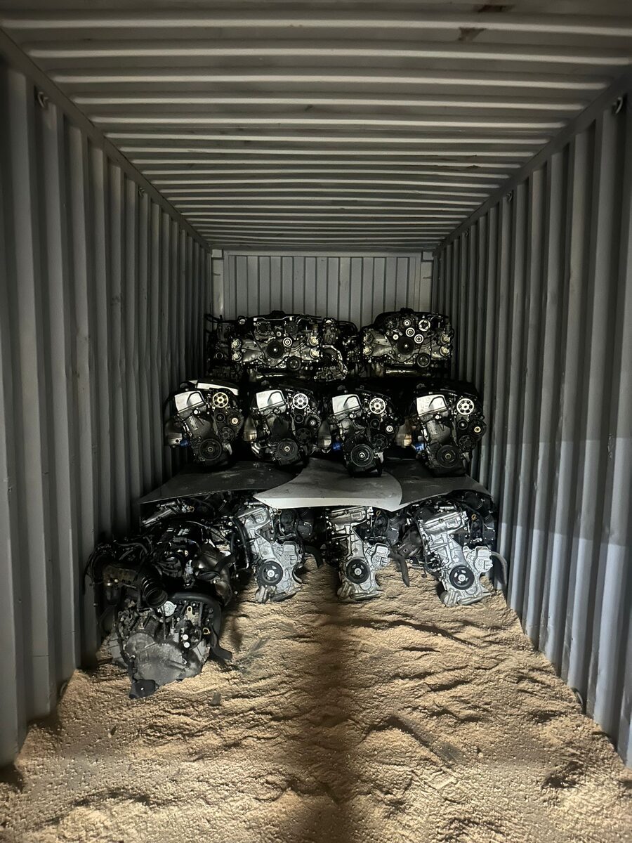 Engines stacked inside a container with an open area of packing material