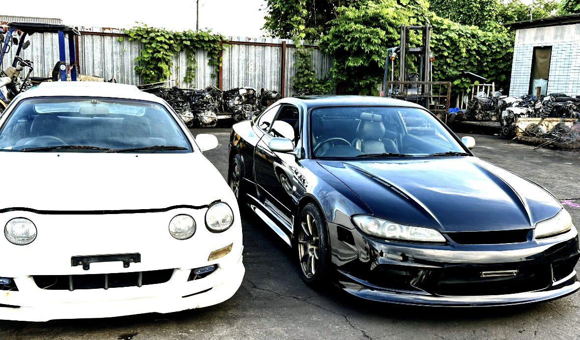 Two used cars parked outdoors