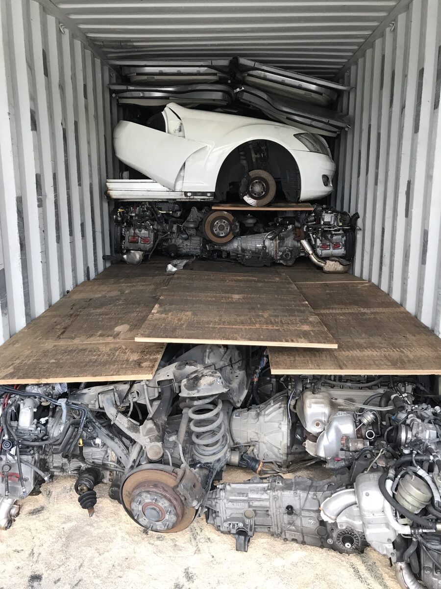 White vehicle section and engines separated by wooden loading platforms