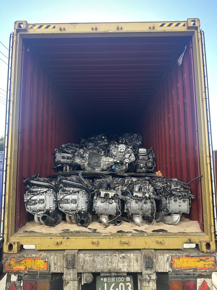 Engines viewed through the open doors of a shipping container