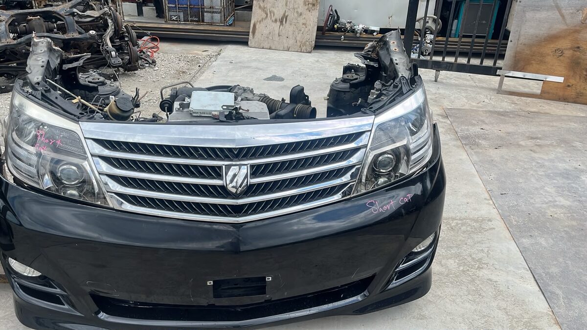 Dark-colored used car parked in a vehicle yard