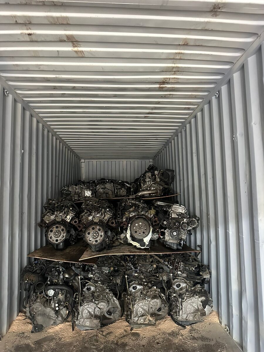 Stacked engines beneath the ribbed roof of a shipping container