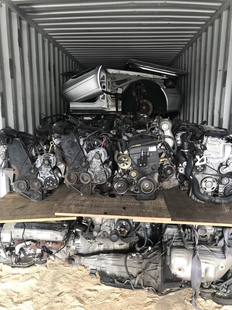 Stacked engines beneath a vehicle body section inside a container