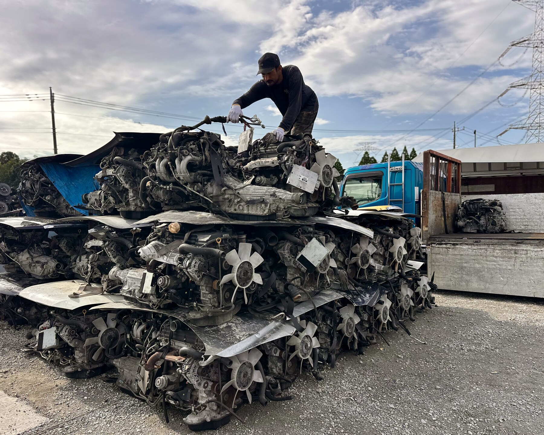 Worker on a rack of engines in the yard