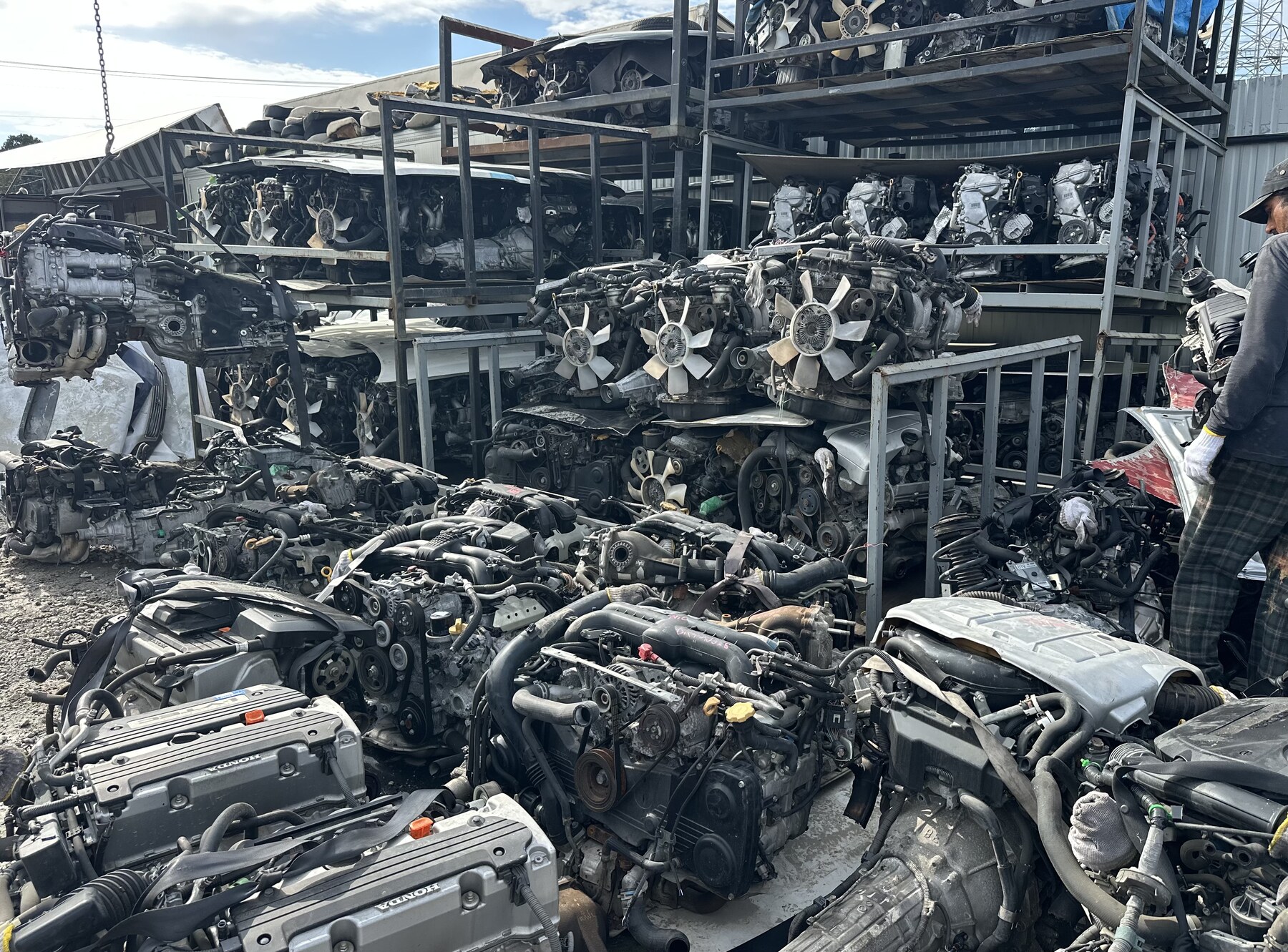Used engines stored on racks and on the ground in the yard