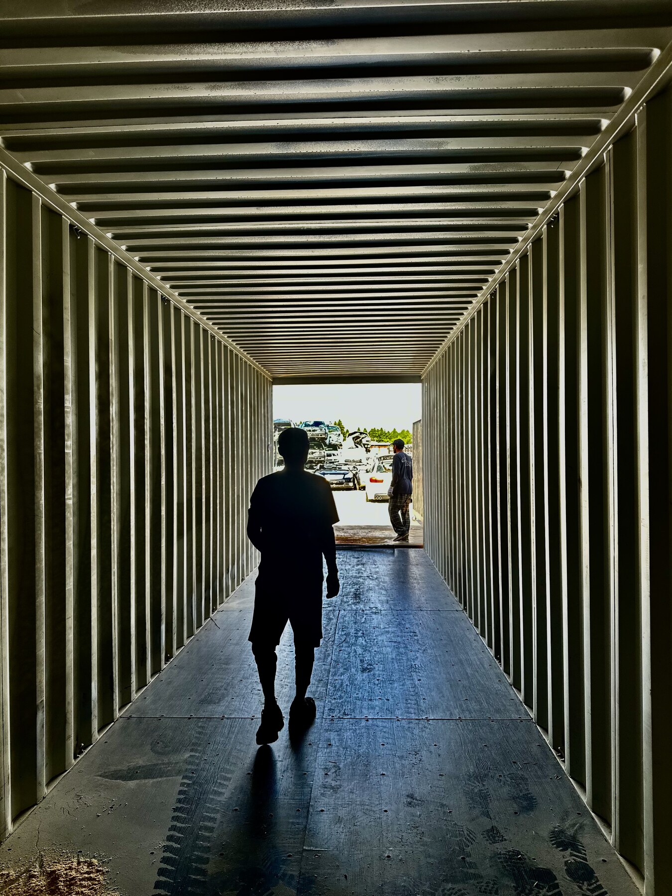 Worker inside an empty shipping container