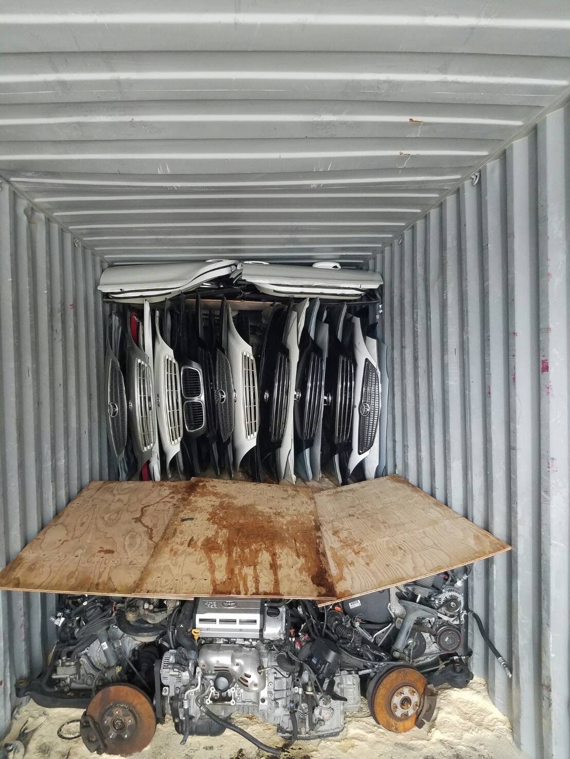 Used engines packed on pallets inside a shipping container